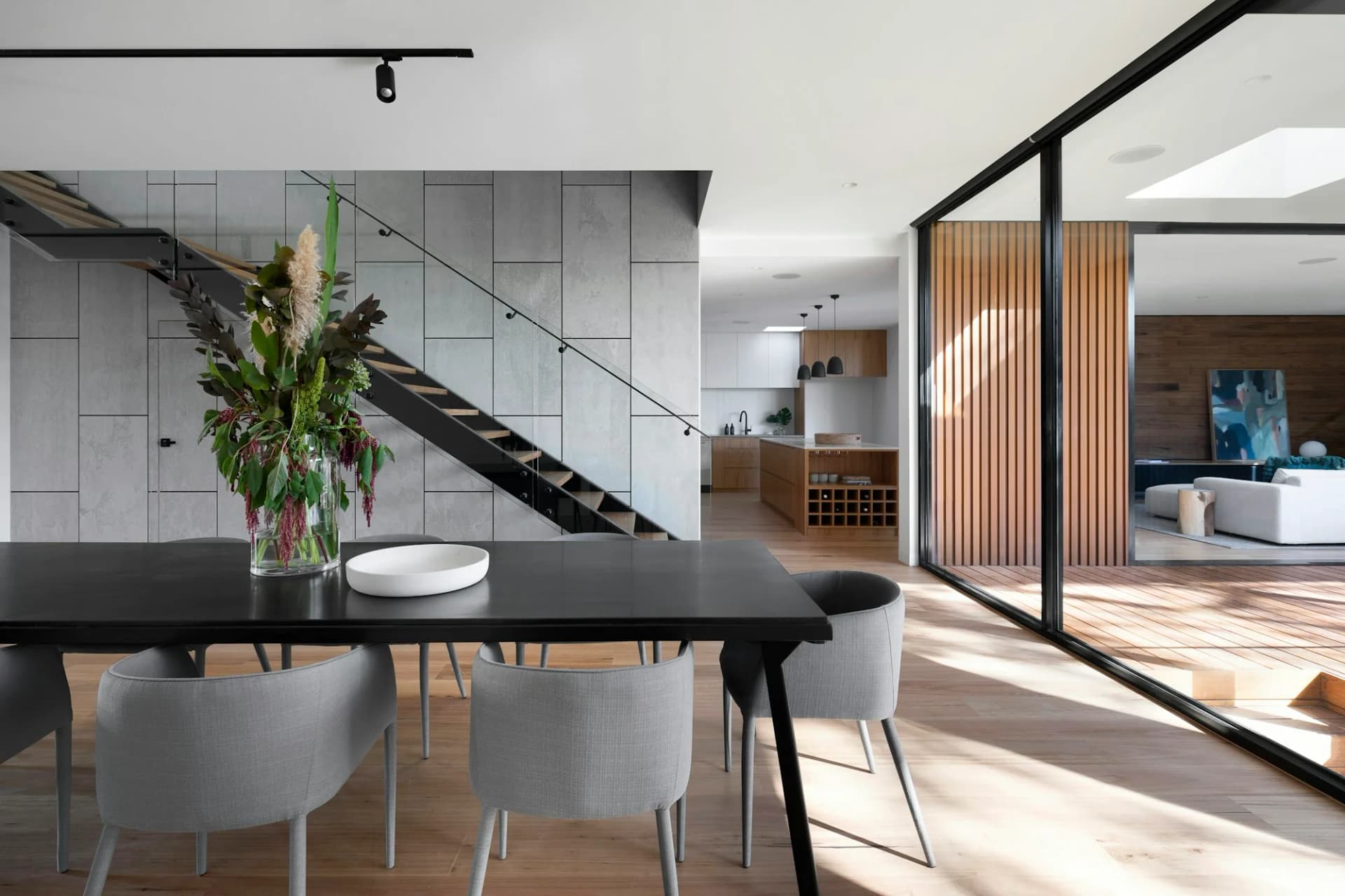 Modern dining room with timber details and expansive windows