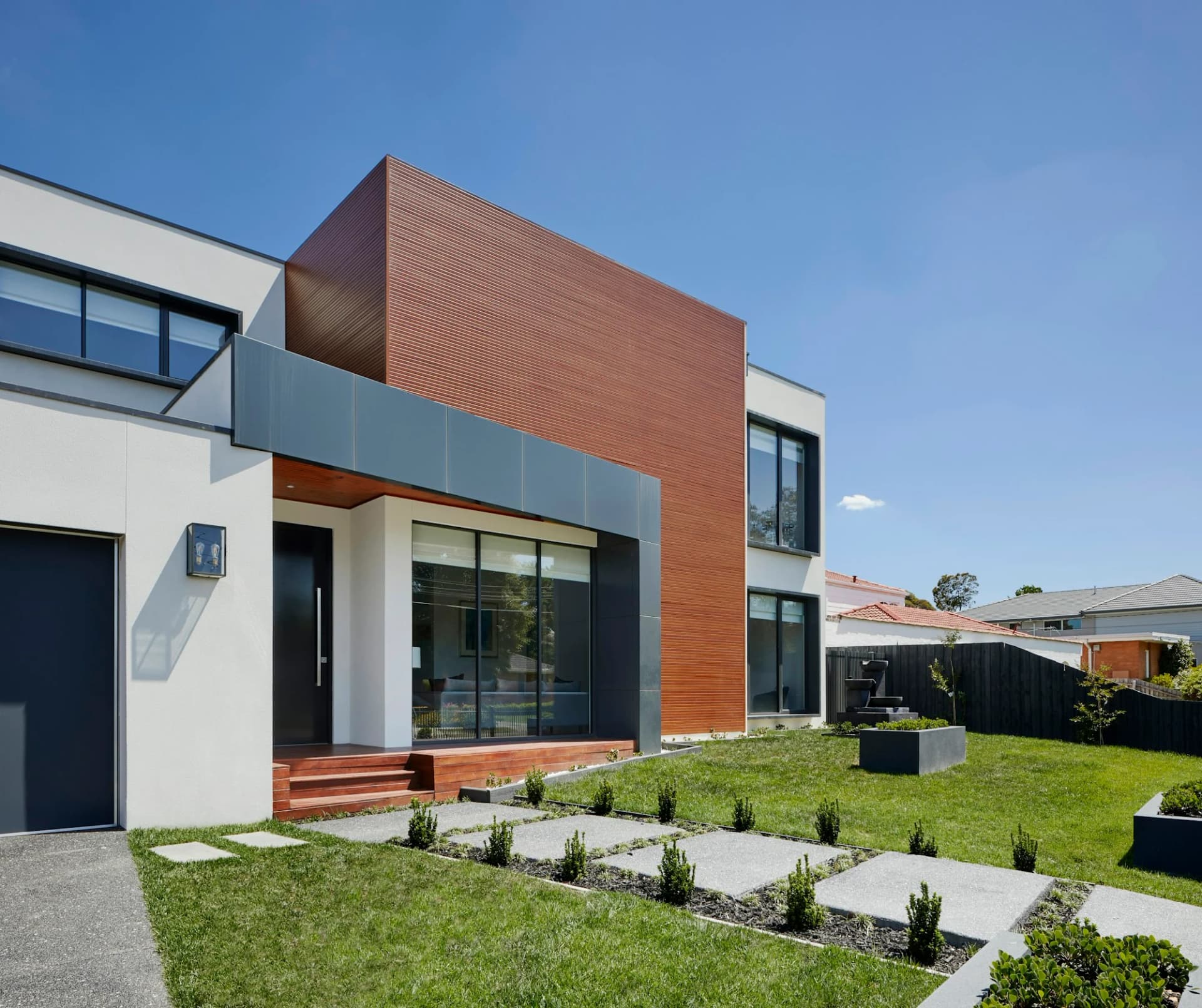 Contemporary residence with timber cladding and expansive windows